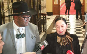 Māori Party MPs Rawiri Waititi and Debbie Ngarewa-Packer speak to media after leaving the debate chamber in protest.