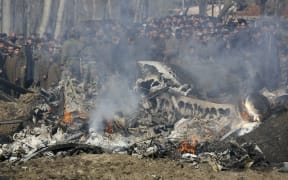 Kashmiri villagers gather near the wreckage of an Indian aircraft after it crashed in Budgam area, outskirts of Srinagar, Indian controlled Kashmir, on 27 February.