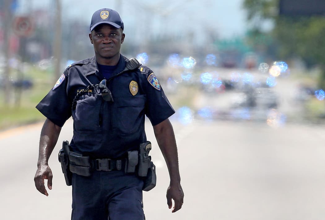 A police officer patrols in Baton Rouge after three officers were killed in a shooting.