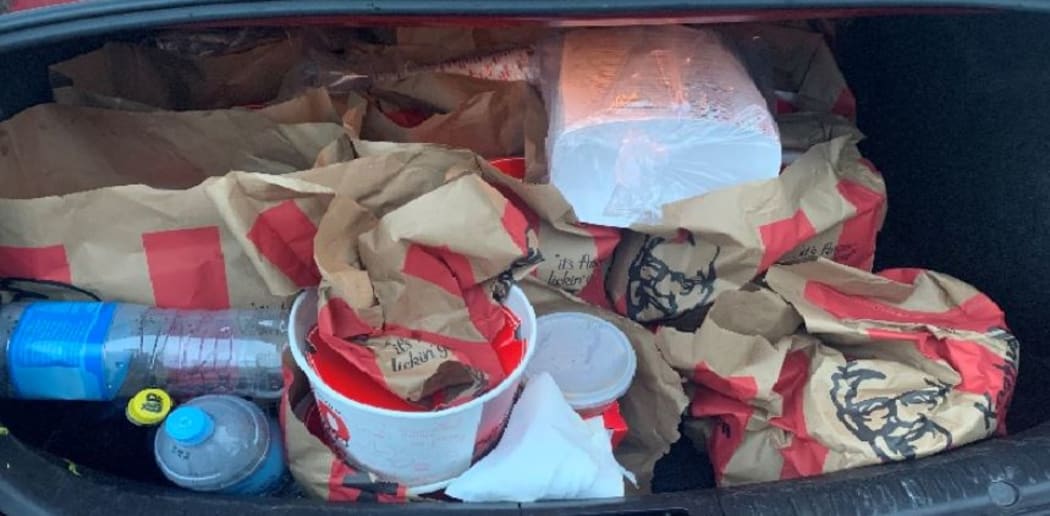 There was more than $100,000 in cash and "a car boot full" of KFC, police said.