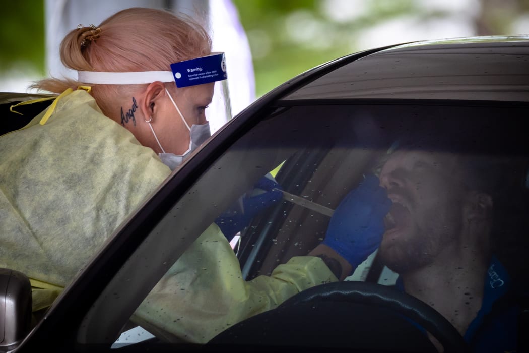 A healthcare worker tests a person at a drive-through Covid-19 testing clinic on the first day of a snap lockdown at Murarrie in Brisbane on January 9.