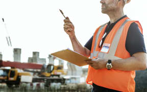Man in high vis gear at building site.Architecture, Construction Safety, First Concept image.