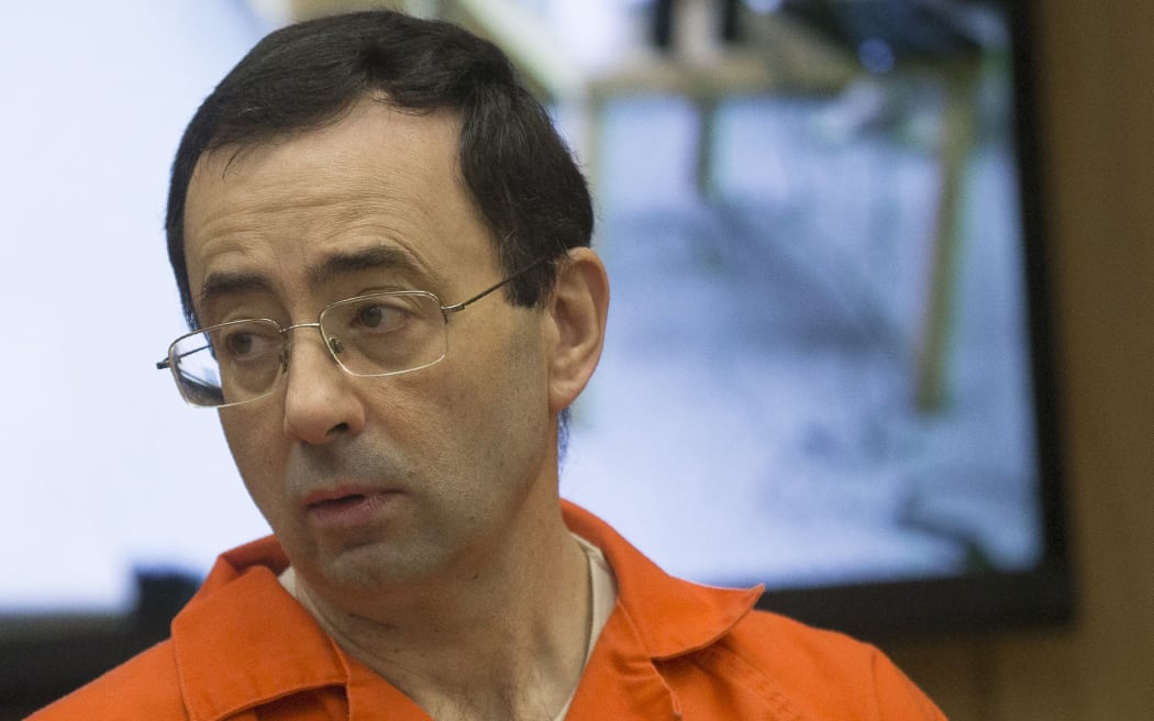 (FILES) Former Michigan State University and USA Gymnastics doctor Larry Nassar appears in court for his final sentencing phase in Eaton County Circuit Court in Charlotte, Michigan, on February 5, 2018. Larry Nassar, the former USA Gymnastics team doctor convicted of sexually assaulting hundreds of athletes, was in stable condition on July 10, 2023, after being stabbed multiple times by another inmate, a prison union official said. Nassar, 59, was attacked on the afternoon of July 9, 2023, at the federal USP Coleman II prison in Sumterville, Florida, where he is serving his sentence, Joe Rojas, the president of the local correctional officers union, told AFP. (Photo by RENA LAVERTY / AFP)