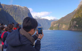 Tourist in Milford Sound