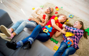 Portrait of three teen friends playing lego together