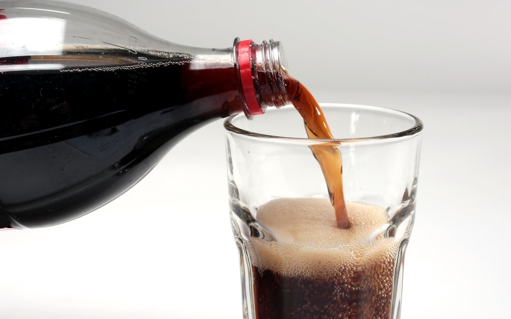 Photo Diego Opatowski / RNZ.  Coca cola. Coke. Pouring Cola isolated on white