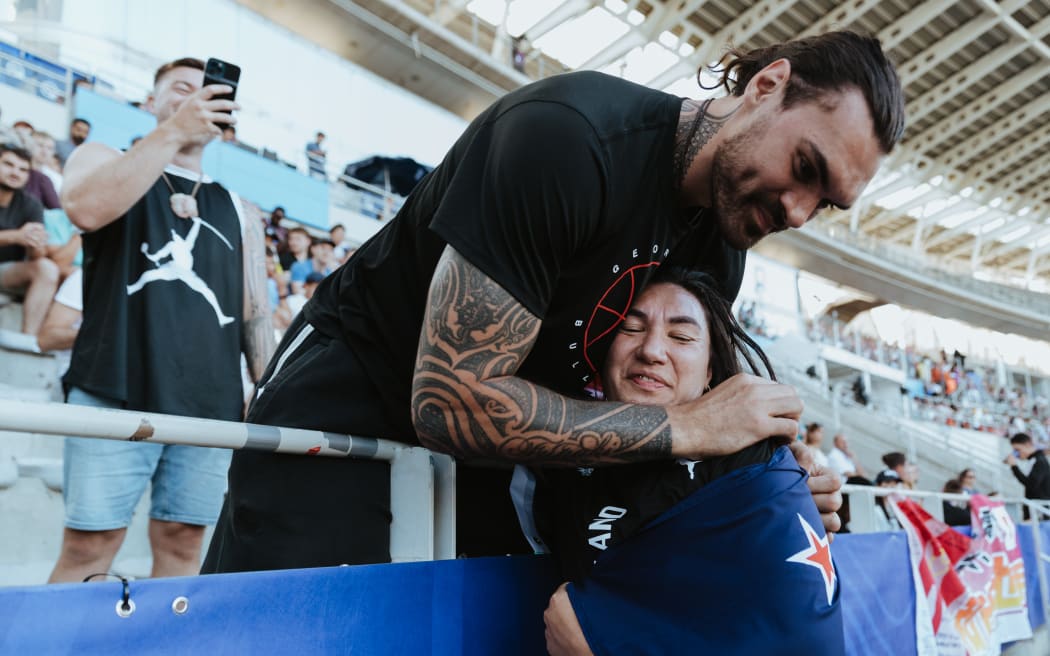 Lisa Adams is hugged by Steven Adams after winning the shot put gold at the 2023 Para World Athletics Championships in Paris.