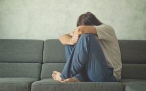person sitting on couch distressed