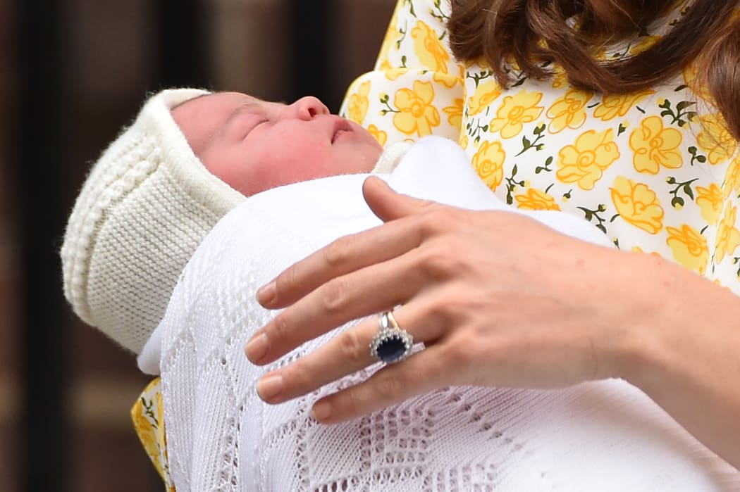 Catherine, Duchess of Cambridge holds her newly-born daughter.