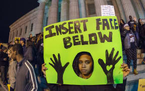 Protestors demonstrate on the steps of the National Portrait Gallery in Washington, DC, one day after the grand jury decision.