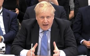 A video grab shows former British Prime Minister Boris Johnson making his opening statement as he attends a Parliamentary Privileges Committee hearing, in central London on 22 March, 2023.