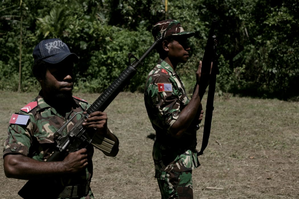 Young West Papuan guerrillas of the OPM or Organisasi Papua Merdeka (Free Papua Movement) at their jungle headquarters.