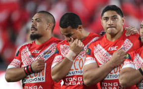 Sika Manu, Will Hopoate and Jason Taumalolo during the Tonga national anthem prior to kickoff against the Kangaroos.