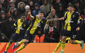 Bournemouth's Argentinian defender #25 Marcos Senesi (C) celebrates with teammates after scoring their third goal during the English Premier League football match between Manchester United and Bournemouth at Old Trafford in Manchester, north west England, on December 9, 2023. (Photo by Oli SCARFF / AFP) / RESTRICTED TO EDITORIAL USE. No use with unauthorized audio, video, data, fixture lists, club/league logos or 'live' services. Online in-match use limited to 120 images. An additional 40 images may be used in extra time. No video emulation. Social media in-match use limited to 120 images. An additional 40 images may be used in extra time. No use in betting publications, games or single club/league/player publications. /