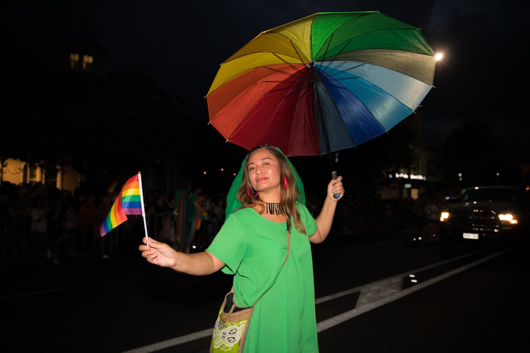 Marama Davidson rocking a rainbow umbrella