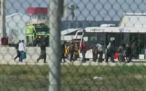 A screenshot from the BBC shows passengers leaving the aircraft in Larnaca.