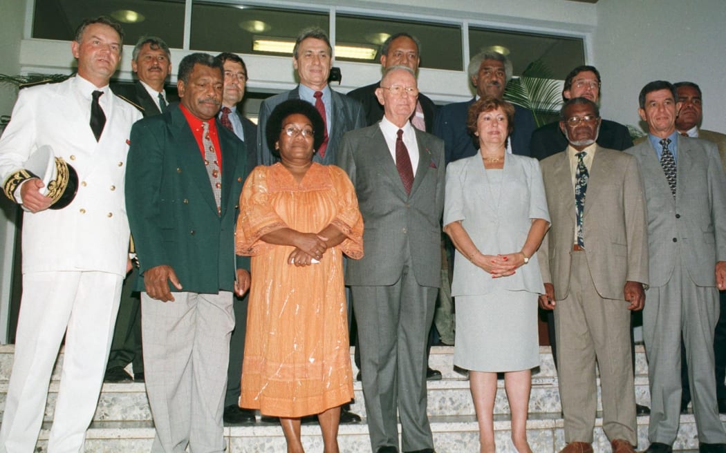 The High Commissioner, Dominique Bur (L), poses with the 11 members of the brand new government of New Caledonia who surround its president Jean Lèques (C), on May 28, 1999 in Noumea. The 54 elected members of the Congress of New Caledonia elected the first collegiate government of 11 members