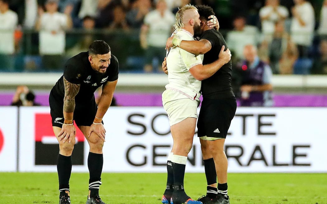Ardie Savea with England's Joe Marler after the game, as Sonny Bill Williams looks on.