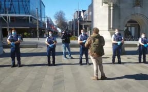 The police line up at an anti-lockdown protest in Christchurch.
