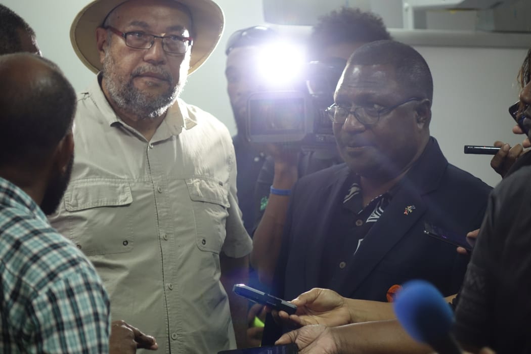 Glare of the media spotlight: Papua New Guinea Electoral Commissioner Patilias Gamato (in black) hears complaints about the 2017 election process by candidates (including Jamie Maxtone-Graham in hat) during polling.