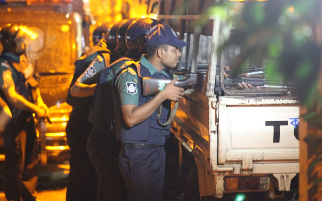 Bangladeshi police stand guard outside the Holey Artisan Bakery cafe,