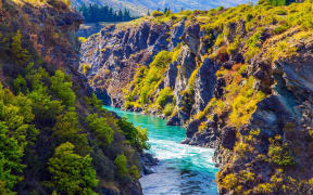 The river with bright green water. Incredible Adventures in New Zealand. Picturesque gorge and river Kawarau between Cromwell and Queenstown. The concept of extreme, active and photo tourism
