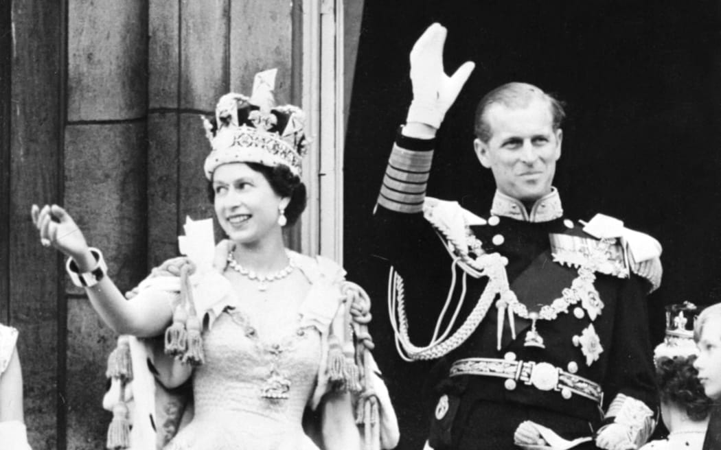 Britain's Queen Elizabeth II (L) accompanied by Britain's Prince Philip, Duke of Edinburgh (R) waves to the crowd, June 2, 1953 after being crowned  at Westminster Abbey in London.