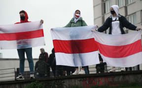 Protesters hold historical white-red-white flags of Belarus during a rally, in Minsk, Belarus.