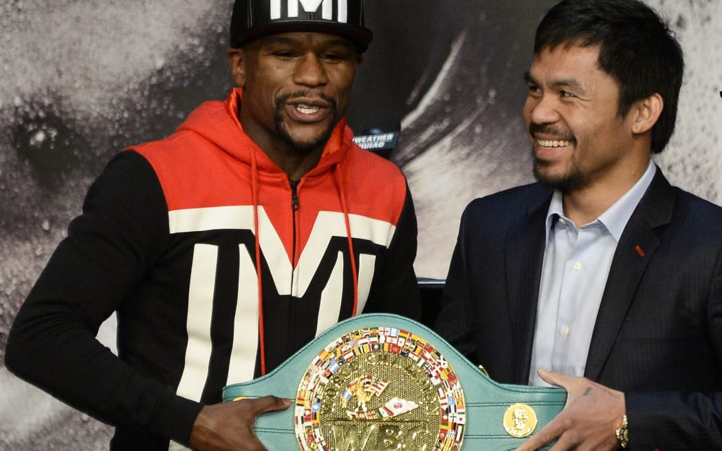 Floyd Mayweather Jnr and Manny Pacquiao pose with the WBO welterweight belt before their fight in April.
