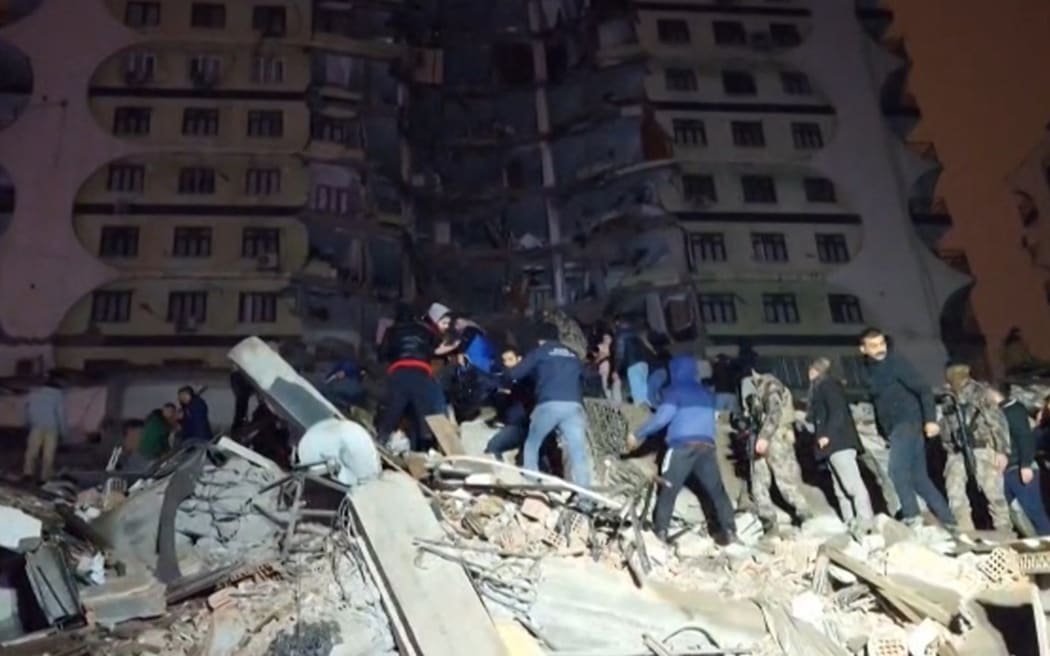 Dans cette capture vidéo d'AFP TV prise le 6 février 2023, des sauveteurs recherchent les victimes d'un tremblement de terre de magnitude 7,8 qui a frappé Diyarbakir, dans le sud-est de la Turquie, rasant des bâtiments dans plusieurs villes et causant des dégâts en Syrie voisine.