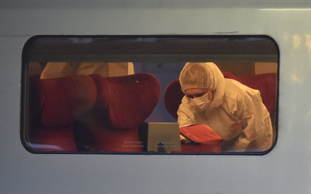 Police inspect a crime scene inside a Thalys train of French national railway operator SNCF.