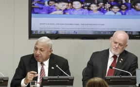 Josaia Voreqe Bainimarama (left), Prime Minister of the Republic of Fiji, briefs journalists on the "Implementation of the Paris Agreement - Consequences for the Humanitarian Summit and the 2030 Development Agenda". Peter Thomson (right), Permanent Representative of Fiji to the UN.