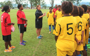 PNG Under 20 women's coach Lisa Cole instructs players at training.