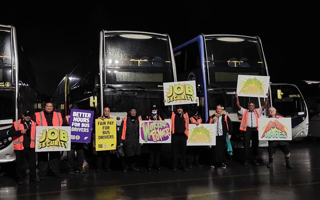 Bus drivers at the New Lynn depot hold placards as they take strike action on Tuesday 11 July 2023.