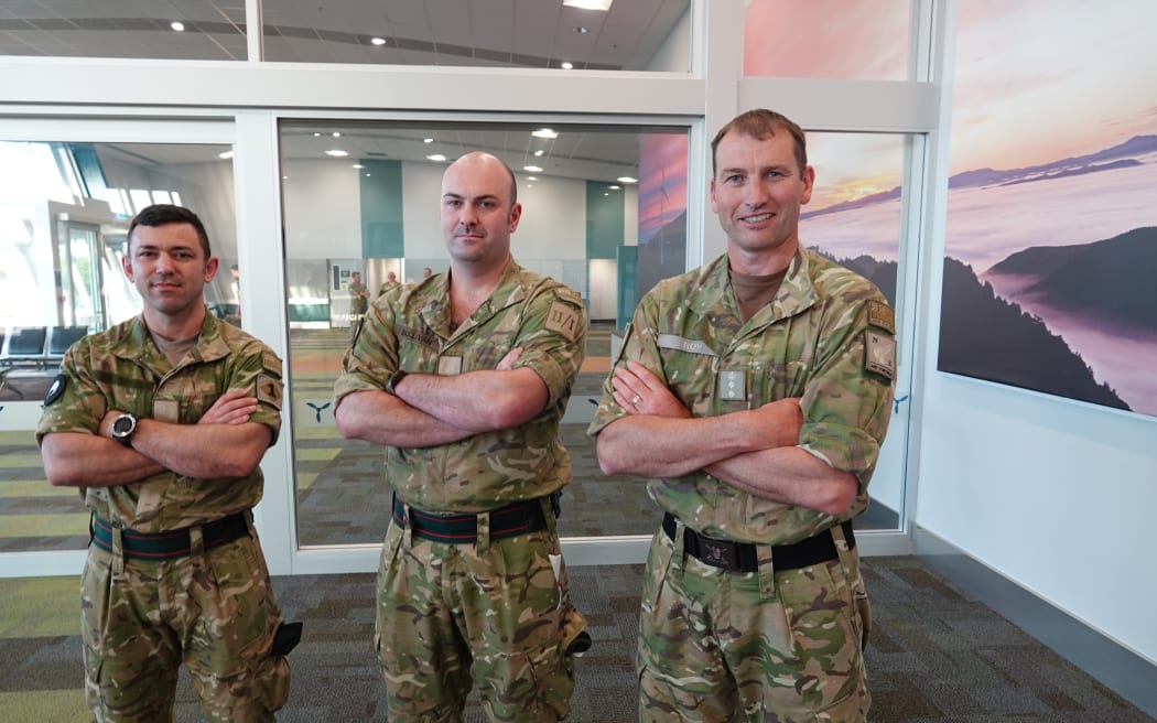 Major Thomas Kelly, left, and Major Josh Sullivan, centre, are met by Colonel Duncan Roy on their return to New Zealand.
