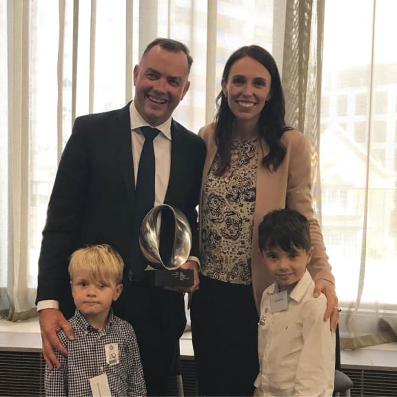 Damian Christie and his sons after being awarded the Prime Ministers Science Communication Prize by Jacinda Ardern