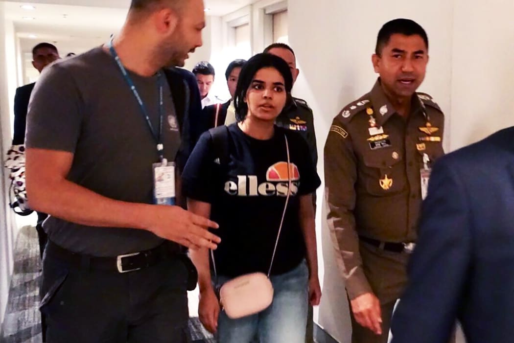 January 7, 2019 18-year-old Saudi woman Rahaf Mohammed al-Qanun (2nd-L) escorted by the Thai immigration officer and United Nations High Commissioner for Refugees (UNHCR) officials at the Suvarnabhumi international airport in Bangkok.