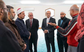 Dr Anwar Ghani (red) takes the Jewish visitors on a tour of a Christchurch Mosque.