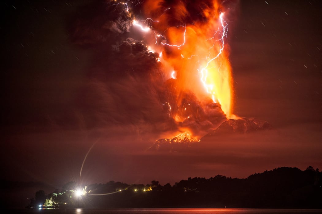 A night shot - from Frutillar, southern Chile - shows lava, ash and lightning caused by the volcano on 23 April.