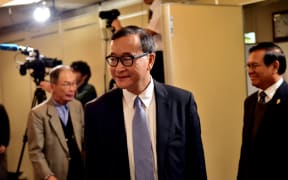 Cambodia's main opposition Cambodia National Rescue Party president Sam Rainsy arrives at a conference room to speak to the press in Tokyo.