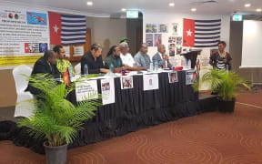 Governor of Papua New Guinea's National Capital Powes Parkop (with mic) speaks at OPM (Free Papua Movement) press conference in Port Moresby 31 January 2019