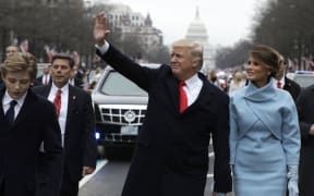 President Donald Trump and Melania Trump walking part of the way during the inaugural parade to the White House.