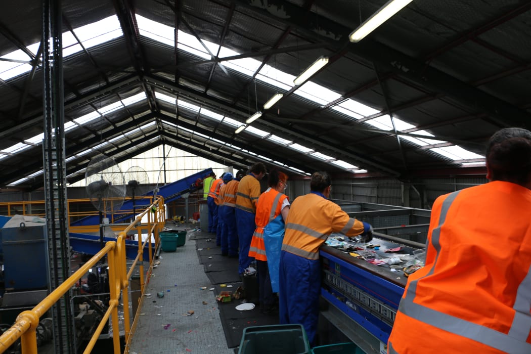 Employees sort through recycling material at the Wellington recycling facility at Seaview.