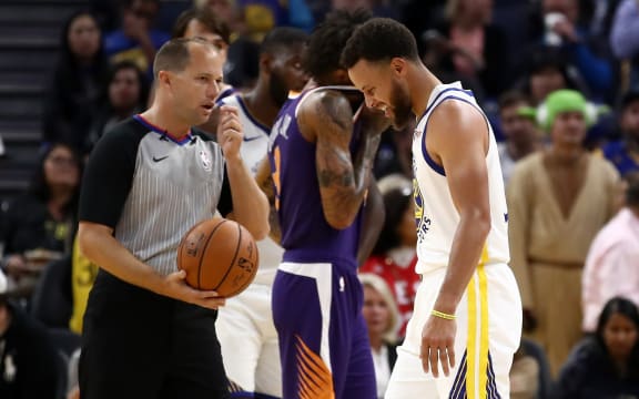 Stephen Curry #30 of the Golden State Warriors grimaces after he was injured in the second half of their game against the Phoenix Suns at Chase Center on October 30, 2019 in San Francisco, California.