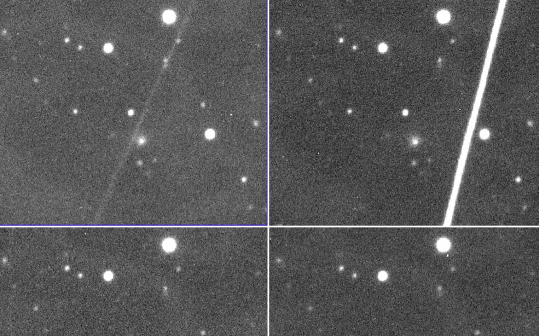 Imagen en blanco y negro del cometa C/2014 UN271 (Bernardinelli-Bernstein) y algunos rastros de luz que dejan los satélites en la imagen