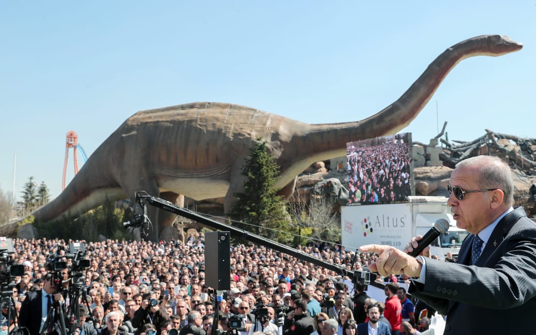 Turkish President Recep Tayyip Erdogan speaking next to a model dinosaur during the opening ceremony of the Wonderland Eurasia theme park in Ankara.