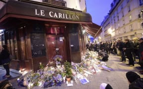 Tributes left at the Le Carillon bar and neighbouring  Le Petite Cambodge restaurant, site of one of the attacks.