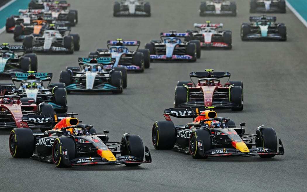 Red Bull drivers Max Verstappen and Sergio Perez lead at the start of a race.