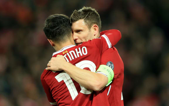 Philippe Coutinho of Liverpool celebrates with teammate James Milner.
