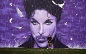 Artist Graham Hoete with his massive Prince wall mural.